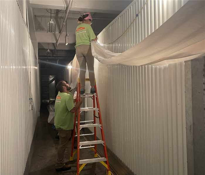 2 SERVPRO employees on a job site.